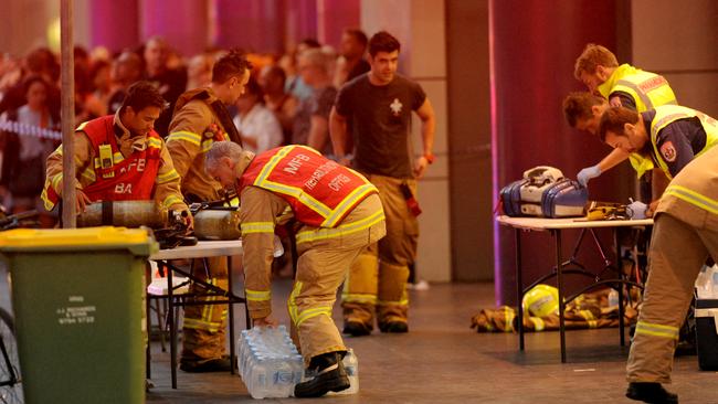 Fire crews and paramedics set up at the base of the tower. Picture: Andrew Henshaw