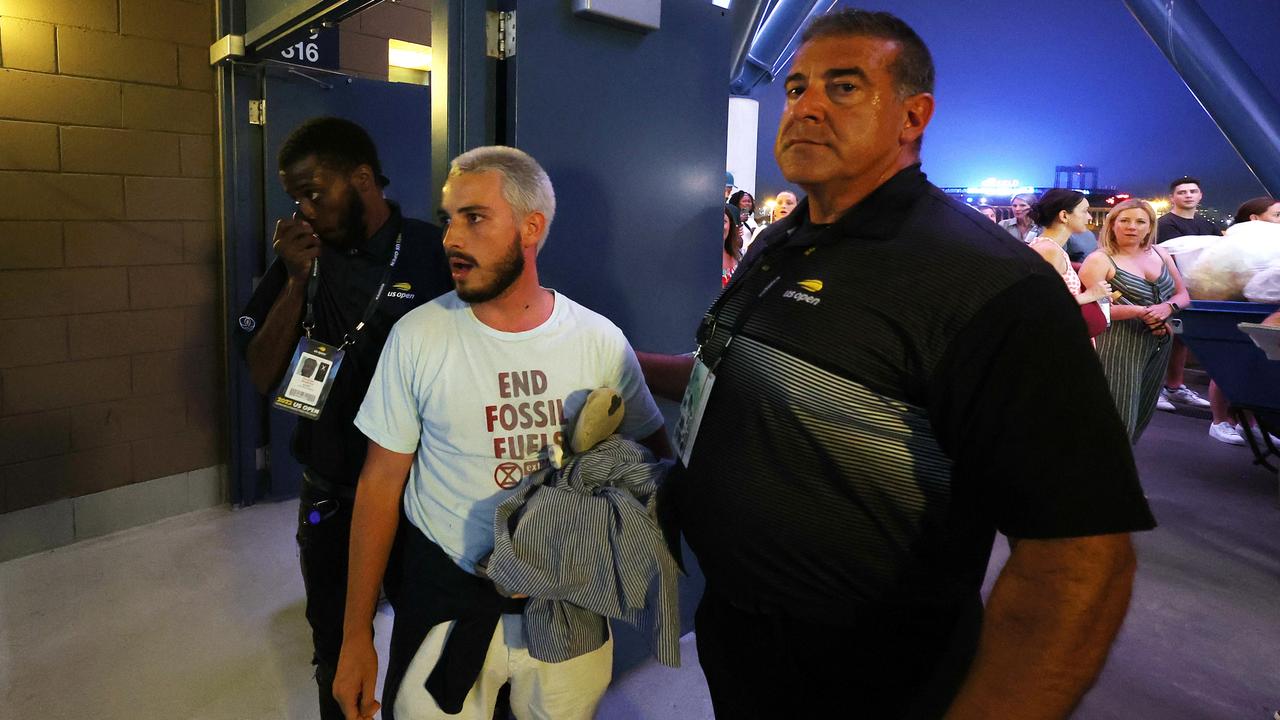 A protester is removed for causing a delay. (Photo by Al Bello/Getty Images)