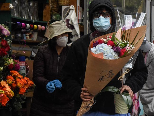 A doctor from Mt. Sinai Hospital in New York buys bouquets for Mother's Day on Sunday (local time). Picture: Getty Images/AFP