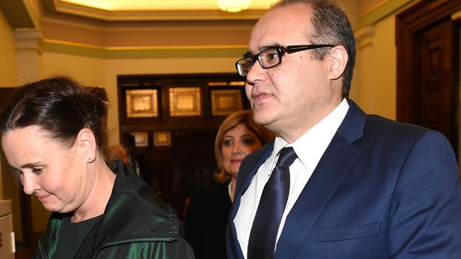 Jane Garrett and Adem Somyurek leave a caucus meeting.