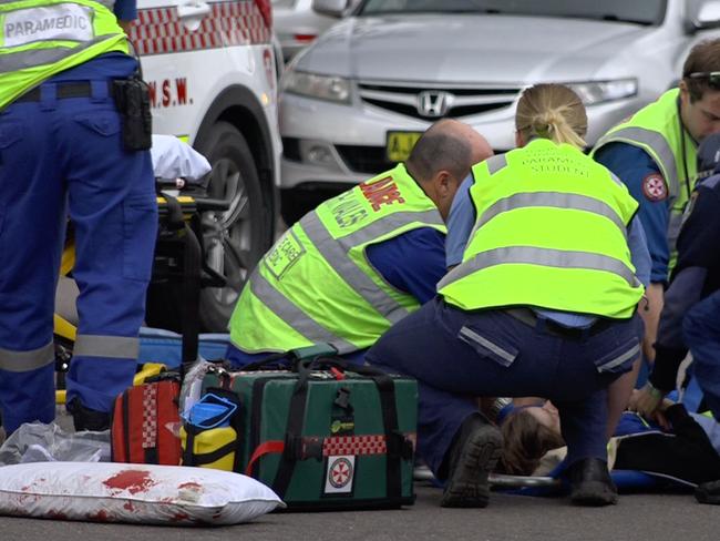 Paramedic work on the boy after he was struck by the trail bike. Picture: David Cleverly.