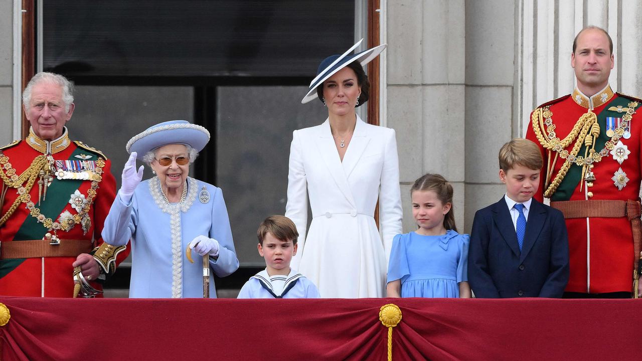 Queen Elizabeth II (2L) stands with from left, Britain's Prince Charles, Prince of Wales, Britain's Prince Louis of Cambridge, Britain's Catherine, Duchess of Cambridge, Britain's Princess Charlotte of Cambridge, Britain's Prince George of Cambridge, Britain's Prince William, Duke of Cambridge, to watch a special fly-past from Buckingham Palace balcony following the Queen's Birthday Parade, the Trooping the Colour, as part of Queen Elizabeth II's platinum jubilee celebrations, in London. (Photo by Daniel LEAL / AFP)