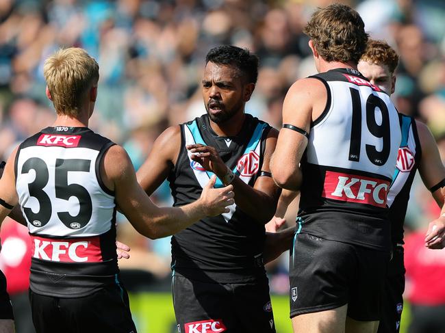 ADELAIDE, AUSTRALIA - MARCH 22: Willie Rioli of the Power celebrates a goal with team mates during the 2025 AFL Round 02 match between the Port Adelaide Power and the Richmond Tigers at Adelaide Oval on March 22, 2025 in Adelaide, Australia. (Photo by Sarah Reed/AFL Photos via Getty Images)