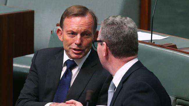 Tony Abbott and Christopher Pyne shake hands during a sitting of the House of Representatives at Parliament House in Canberra in 2017. Picture Kym Smith