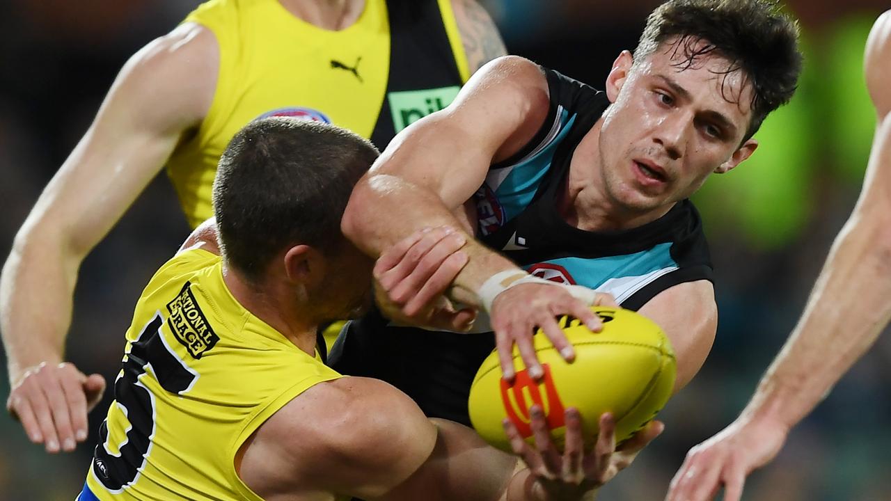 Connor Rozee tackled by Jack Ross at Adelaide Oval. Picture: Mark Brake/Getty Images