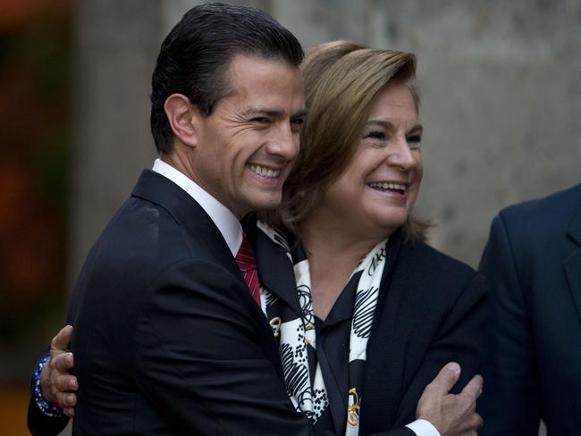 Got him ... Mexican President Enrique Pena Nieto, centre, hugs Attorney General Arely Gomez. Picture: AP