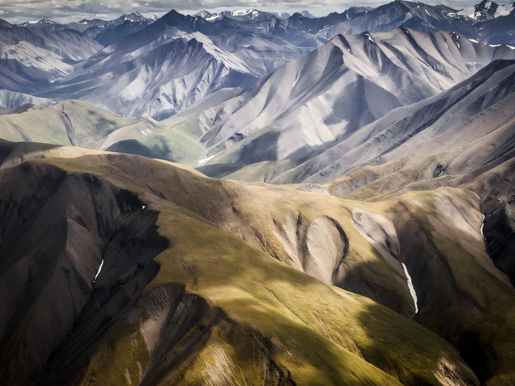 Photo by Alain Boudreau / National Geographic Nature Photographer of the Year contest MacKenzie mountains, NWT, Canada Rich colours fading into the grey ruggedness of the Makenzie Mountains approximately 200 km NW of the Nááts'ihch'oh National Park Reserve