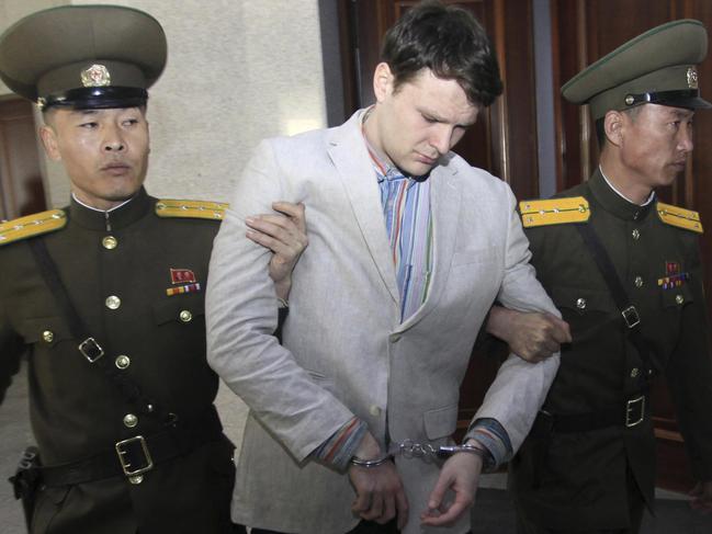 FILE - In this March 16, 2016, file photo, American student Otto Warmbier, center, is escorted at the Supreme Court in Pyongyang, North Korea. The death last week of American student Warmbier, who fell into a coma after being arrested in North Korea, has raised questions about whether his tour agency was adequately prepared for its trips into the hard-line communist state. The Young Pioneer Tours agency built up a business attracting young travelers with cut-rate, hard-partying adventures into one of the worldâ€™s most isolated countries. (AP Photo/Jon Chol Jin, File)