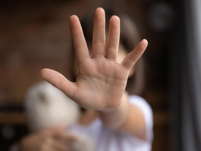 Crop close up of little girl child stretch hand show no gesture protest against domestic violence. Small teen child stand against discrimination or school abuse. Childhood problem, voice concept.