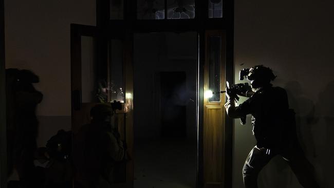 North Queensland Warfighter multi-nation military exercises in the Ingham region. Australian Army soldiers from the 1st Battalion, The Royal Australian Regiment conduct a clearance at a night raid during the North Queensland Warfighter Exercise in Ingham. Picture: Supplied