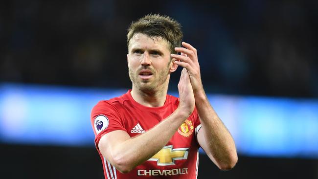 (FILES) This file photo taken on April 27, 2017 shows Manchester United's English midfielder Michael Carrick applauding their fans at the end of the English Premier League football match between Manchester City and Manchester United at the Etihad Stadium in Manchester, north west England, on April 27, 2017. Manchester United's Michael Carrick's rallying call 'We'll stay together and stay strong' summed up the sporting world's response Sunday to the latest terror outrage that left seven dead and dozens injured in London. / AFP PHOTO / Paul ELLIS / RESTRICTED TO EDITORIAL USE. No use with unauthorized audio, video, data, fixture lists, club/league logos or 'live' services. Online in-match use limited to 75 images, no video emulation. No use in betting, games or single club/league/player publications.  /