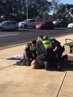 A woman is arrested by police for breaching stay-at-home coronavirus rules. Picture: Facebook.