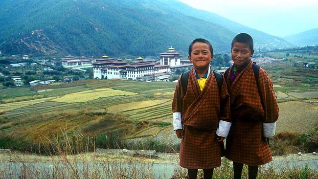 Two Bhutanese boys wearing traditional dress, a gho — a knee-length robe tied at the waist. Supplied.