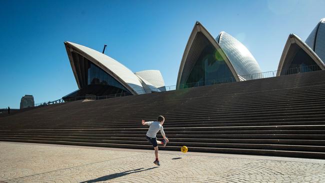 With an unusual lack of crowds, the Opera House steps became this boy’s playground. Picture: Julian Andrews