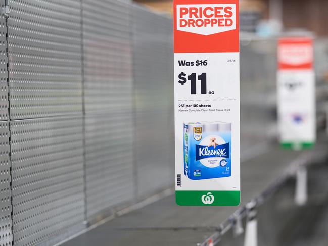 Empty shelves normally stocked with toilet paper rolls at Woolworths Supermarket.