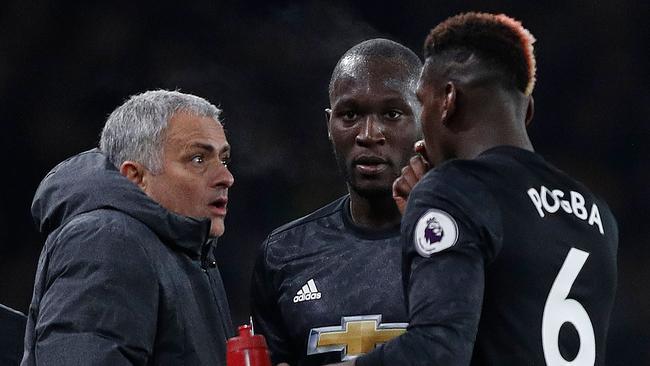 Manchester United's Portuguese manager Jose Mourinho (L) reacts as he talks with Romelu Lukaku (C) and Paul pogba.