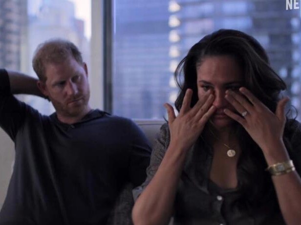 Meghan Markle wipes her eyes as a concerned Prince Harry looks on. Picture: Netflix