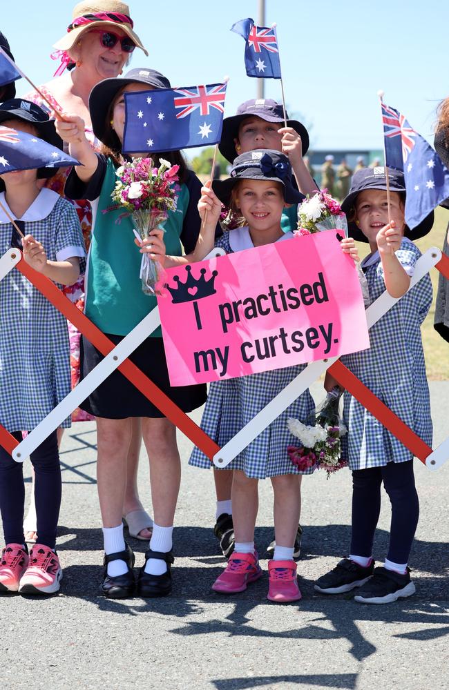 CANBERRA, AUSTRALIA - OCTOBER 21: Children wave flags as King Charles III and Queen Camilla arrive for a visit on October 21, 2024 in Canberra, Australia. The King's visit to Australia will be his first as Monarch, and CHOGM in Samoa will be his first as Head of the Commonwealth. (Photo by Chris Jackson/Getty Images)