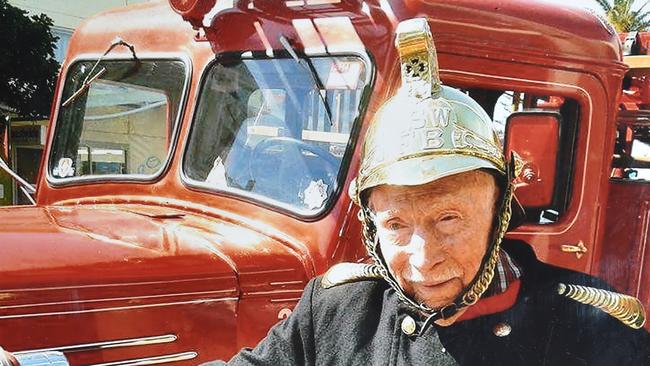 Merton Cooke at 103 standing with his old Mack fire engine that he drove in his early days as a firefighter at The Rocks in Sydney.