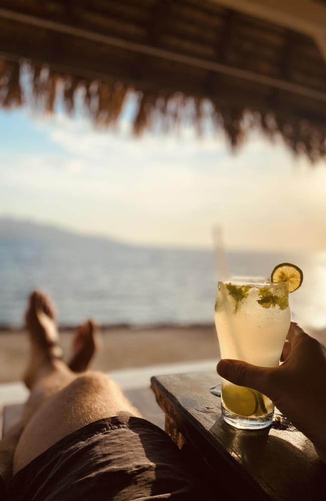 The best way to watch a sunset from the Gili Islands is with a cocktail in one hand, and your feet up. Picture: Supplied