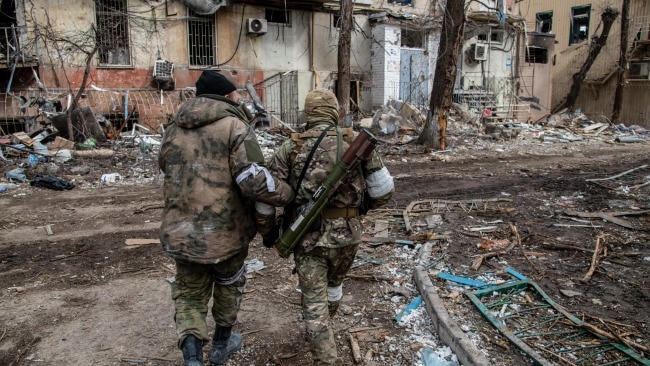 Russian and Chechen soldiers in a devastated Mariupol neighborhood close to the Azovstal frontline on Saturday. Picture: Maximilian Clarke/SOPA Images/LightRocket via Getty Images