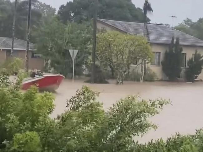 A boat travels through Mullumbimby flood water.