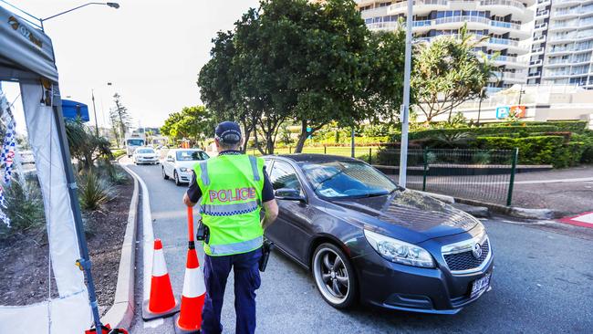 Police at the Queensland border checkpoint between Coolangatta and Tweed Heads. Picture: NIGEL HALLETT