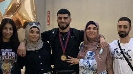 Boxer Taha Ahmad, here with his family, is going to Birmingham