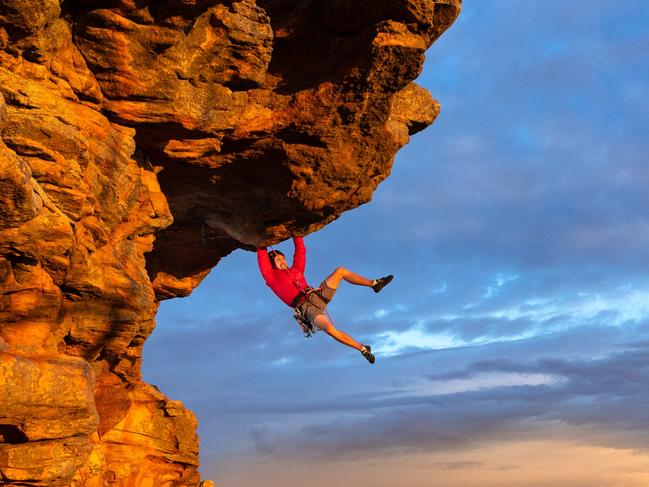 EMBARGO 6AM SATURDAY 6TH APRIL ** WARNING DO NOT USE EMBARGO CONTACT SARAH MATRAY HS PIC DESK IF ANY QUESTIONS** Free climber Tom Perkins swings out on Feeling the Ceiling, a grade 21 climb near the summit of Mount Arapiles at first light. With over two thousand climbs in such a concentrated area of rock this collection of cliffs and gullies is internationally renowned for its quality of climbs and rock, with people traveling from all over to climb here. With climbing bans over large areas already in place due to cultural heritage concerns and more likely to follow, the climbing community are struggling to push back against Parks Victorias broad approach. Picture: Jason Edwards