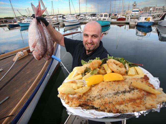 Trident Fish Bar in Queenscliff owner Fonda Tzaninis with some fresh fish and fish and chips. Picture: Glenn Ferguson.