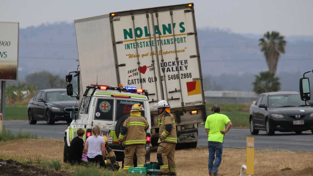 Paramedics on scene assessing patients at morning crash | The Courier Mail