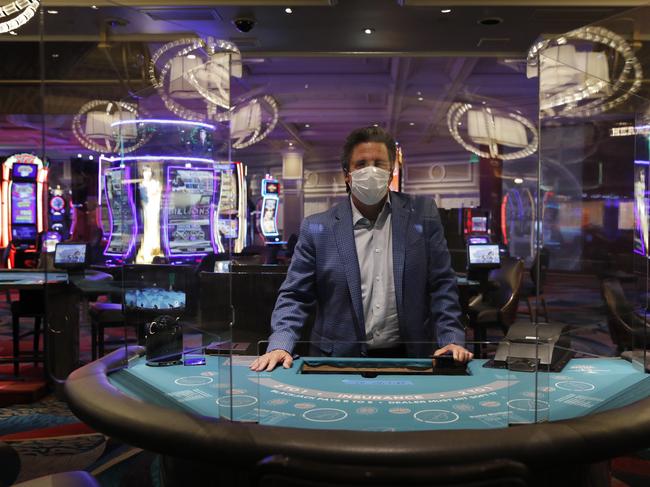 Bill Hornbuckle, acting CEO and president of MGM Resorts International, poses behind acrylic barriers used as a coronavirus safety precaution. Picture: AP