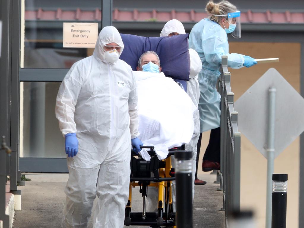 Residents are taken to waiting ambulances at St Basil’s nursing home in Fawkner, Melbourne. Picture: NCA NewsWire/David Crosling