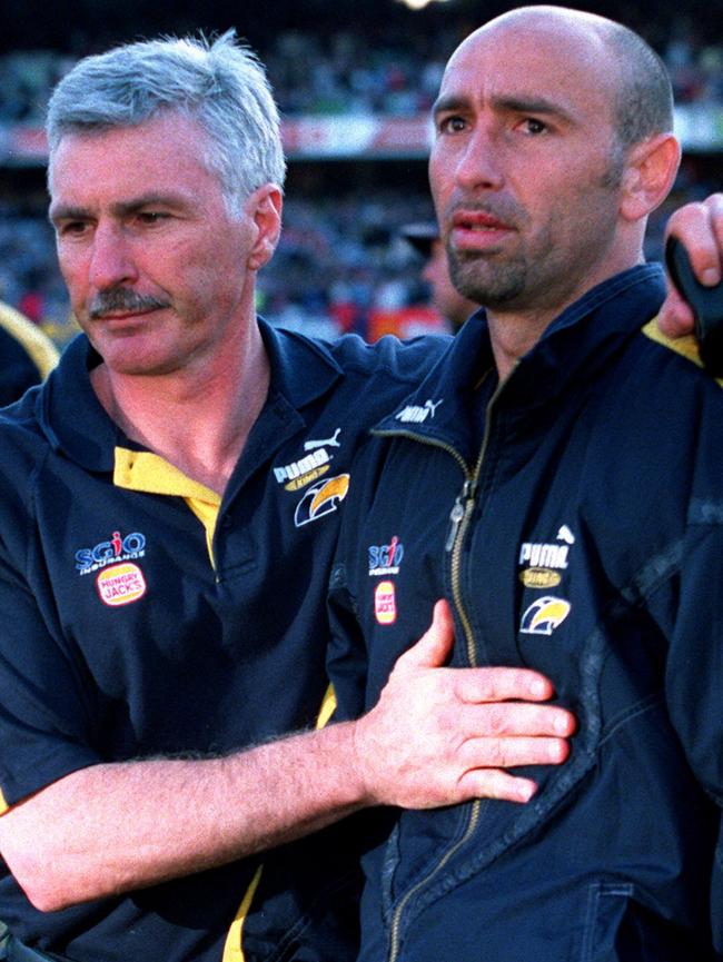 The agony ... Mick Malthouse consoles Peter Matera after the Eagles were knocked out of September by Carlton in 1999.