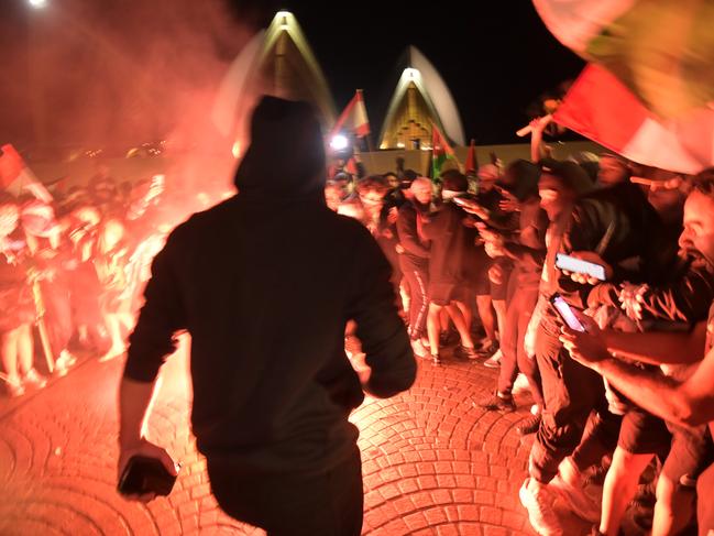 Flares were ignited on the forecourt of the Sydney Opera House during the protest on Monday night. Picture: NCA NewsWire / Jeremy Pipe