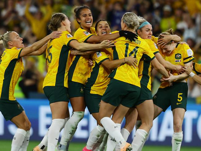 Matildas players celebrate winning the FIFA Womens World Cup Quarter final match between against France at Brisbane Stadium. Picture Lachie Millard