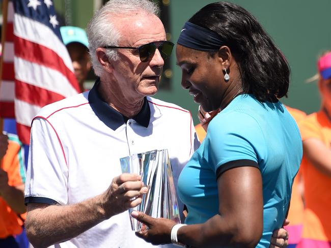 Raymond Moore presents the second place trophy to Serena Williams. Picture: AFP