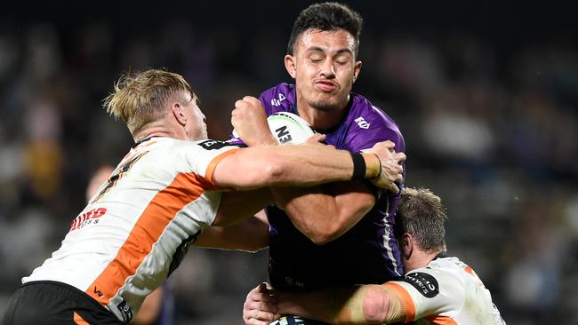 SUNSHINE COAST, AUSTRALIA – SEPTEMBER 19: Tino Faasuamaleaui of the Storm is tackled during the round 19 NRL match between the Melbourne Storm and the Wests Tigers at Sunshine Coast Stadium on September 19, 2020 in Sunshine Coast, Australia. (Photo by Matt Roberts/Getty Images)