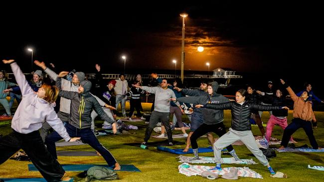 For Salty Sips, the morning starts for some at 6am with yoga under a setting moon. Picture: Mike Burton