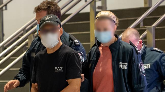 Australian Federal Police escort Chung Chak Lee at Melbourne Airport on Saturday June 11. Picture: Supplied.