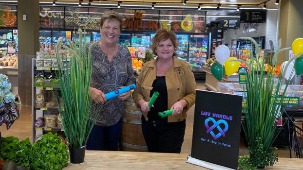 Luv Handle creator Karen Lindsay and Whites IGA's Roz White at the launch of the world-first reusable, dish washable handle fit for any supermarket trolley or basket. Picture: Supplied