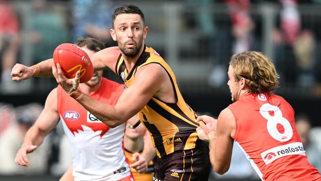 Jack Gunston fires off a handball under pressure. Picture: Steve Bell/Getty Images