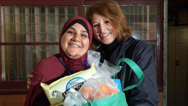 Staples Bag pop-up shop manager Abeer Naji and volunteer Ume Mahesh at the MDSI Blue House in Campbelltown. Pictures: Simon Bullard