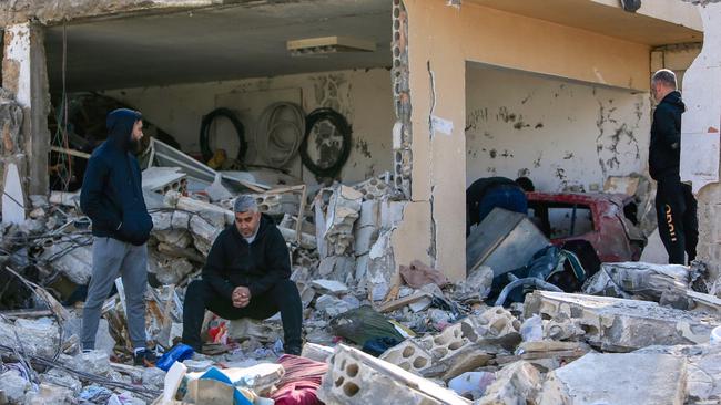 Men check the rubble of a building in Bint Jbeil, in southern Lebanon, following an Israeli bombardment on December 27. Picture: AFP/Getty Images