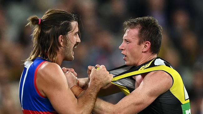 MELBOURNE, AUSTRALIA - APRIL 30: Josh Bruce of the Bulldogs and Dylan Grimes of the Tigers wrestle during the round seven AFL match between the Richmond Tigers and the Western Bulldogs at Melbourne Cricket Ground on April 30, 2021 in Melbourne, Australia. (Photo by Quinn Rooney/Getty Images)