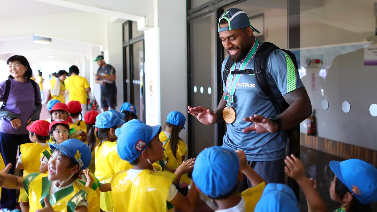 Samu Kerevi of Australia high fives local children following training at Odawara Stadium.