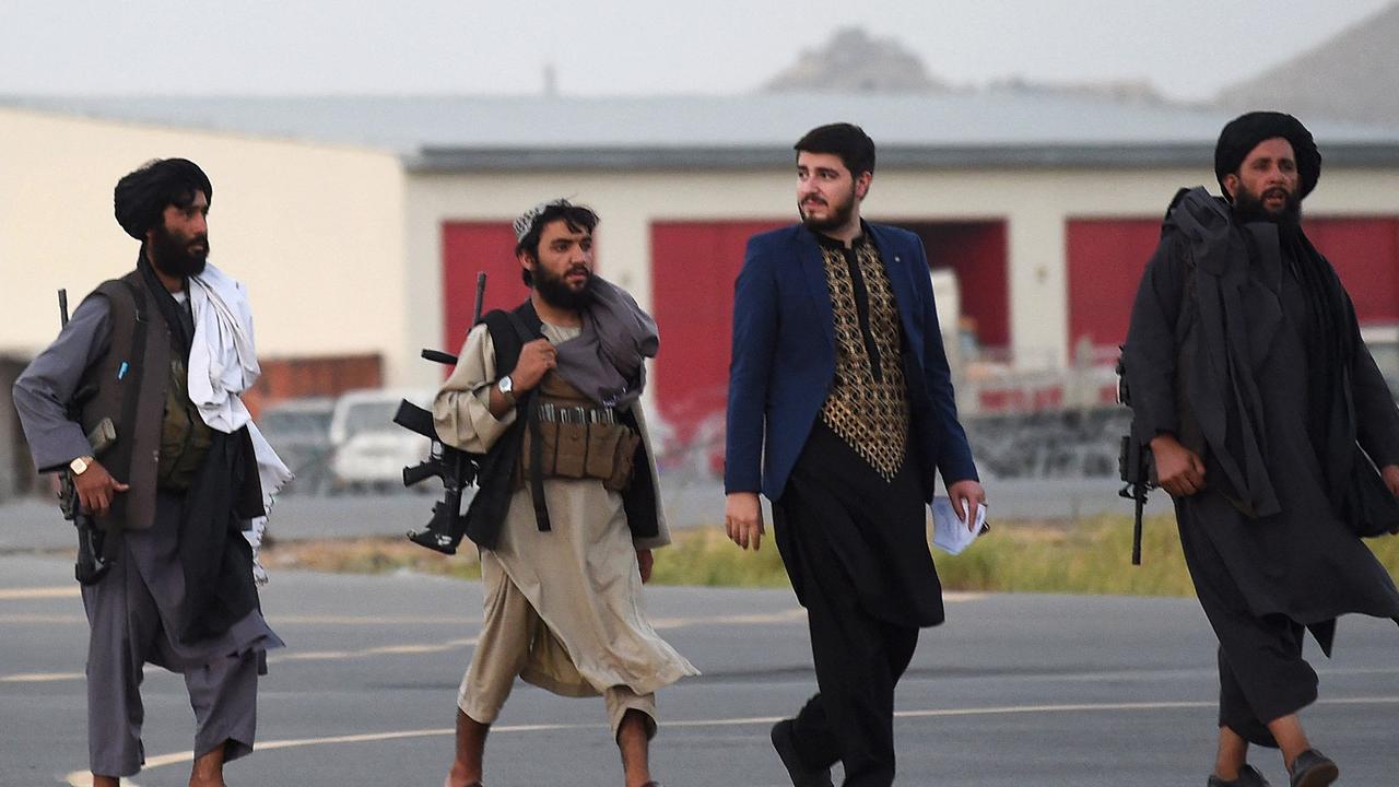 Taliban fighters walk across the tarmac at Kabul Airport on September 9, 2021. Picture: Wakil Kohsar/AFP