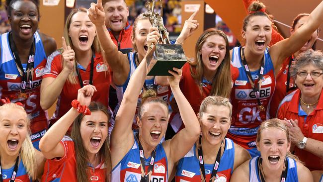 Paige Hadley of the Swifts (centre) with the Super Netball trophy the club claimed for the first time in 2019.