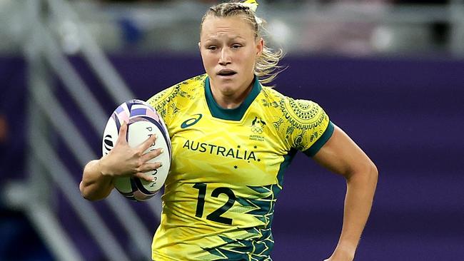 PARIS, FRANCE - JULY 29: Maddison Levi #12 of Team Australia breaks away from Eve Higgins #10 of Team Ireland to score her team's second try during the Women's Rugby Sevens Quarter Final match between Team Ireland and Team Australia on day three of the Olympic Games Paris 2024 at Stade de France on July 29, 2024 in Paris, France. (Photo by Michael Steele/Getty Images)