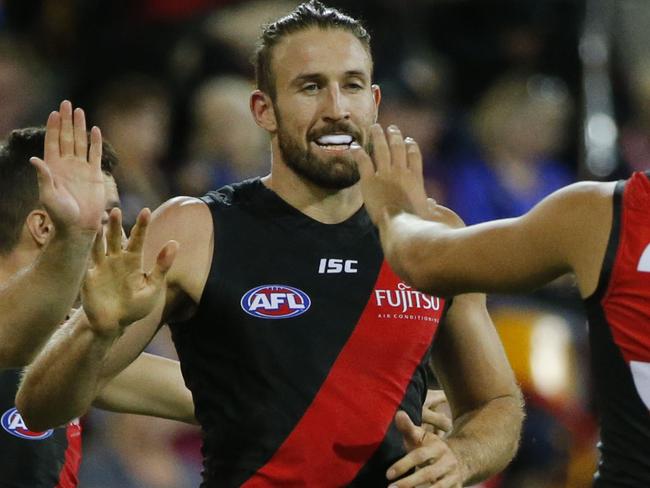 Cale Hooker of the Bombers celebrates with team mates after scoring a goal during the Round 2 AFL match between the Brisbane Lions and the Essendon Bombers at the Gabba in Brisbane, Saturday, April 1, 2017. (AAP Image/Glenn Hunt) NO ARCHIVING, EDITORIAL USE ONLY